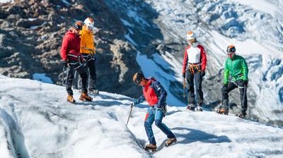 Mountaineers with crampons and ice axe on the glacier
