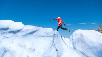 Mountaineer jumps over crevasse
