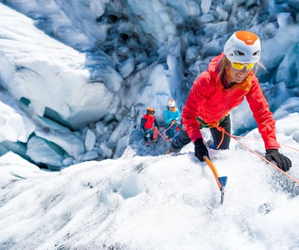 Mountaineer climbing with ice axe