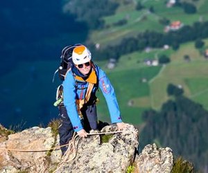 Mountaineer practise rope handling while climbing on a rock ridge