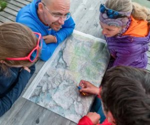 People planning their tour on a map