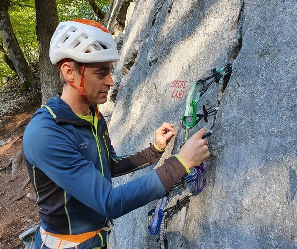 Climber places friends in rock crack