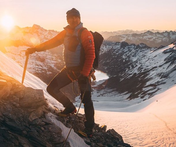 Mountain guide on the Oberaarhorn with sunrise in the background