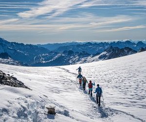 Rope team of glacier hikers at Oberaarjoch is hiking towards Grimsel.
