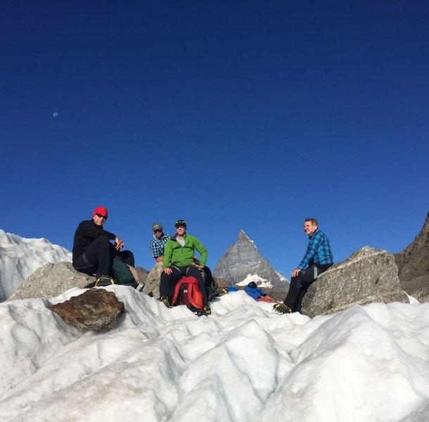 Glacier hikers take a break on the Gorner Glacier with the Matterhorn in the background.