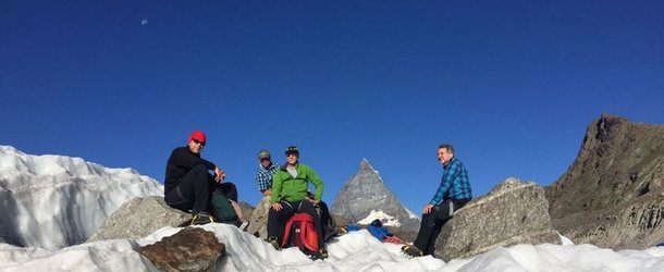 Glacier hikers take a break on the Gorner Glacier with the Matterhorn in the background.