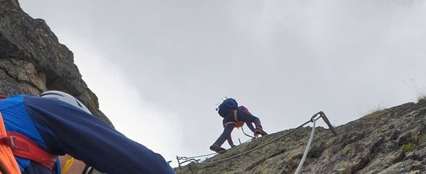 Person climbs a vertical section of the Tierbergli via ferrata