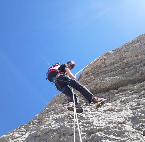 Climber rappels down