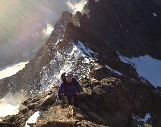 Mountaineer on the ridge of Lauteraarhorn.