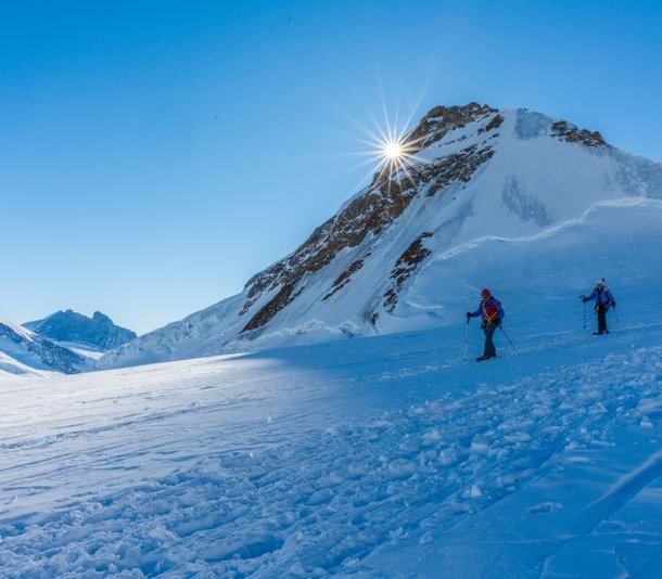 Rope team of snowshoe hikers on the glacier.