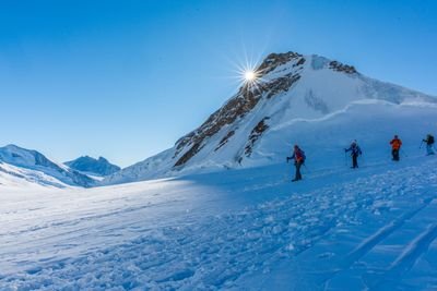 Rope team of snowshoe hikers on the glacier.