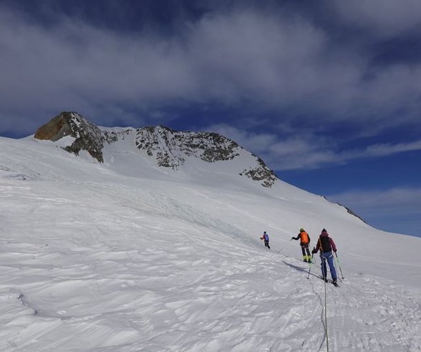 Rope team of ski tourers ascending