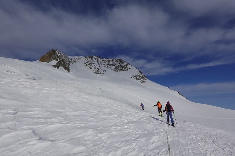 Rope team of ski tourers ascending
