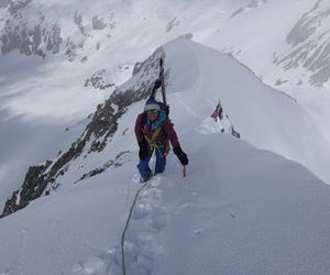 Ski tourer with skis strapped on the ridge.