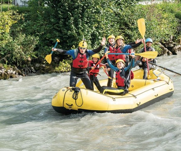 Group laughing and posing during Family Rafting on the Lütschine river.